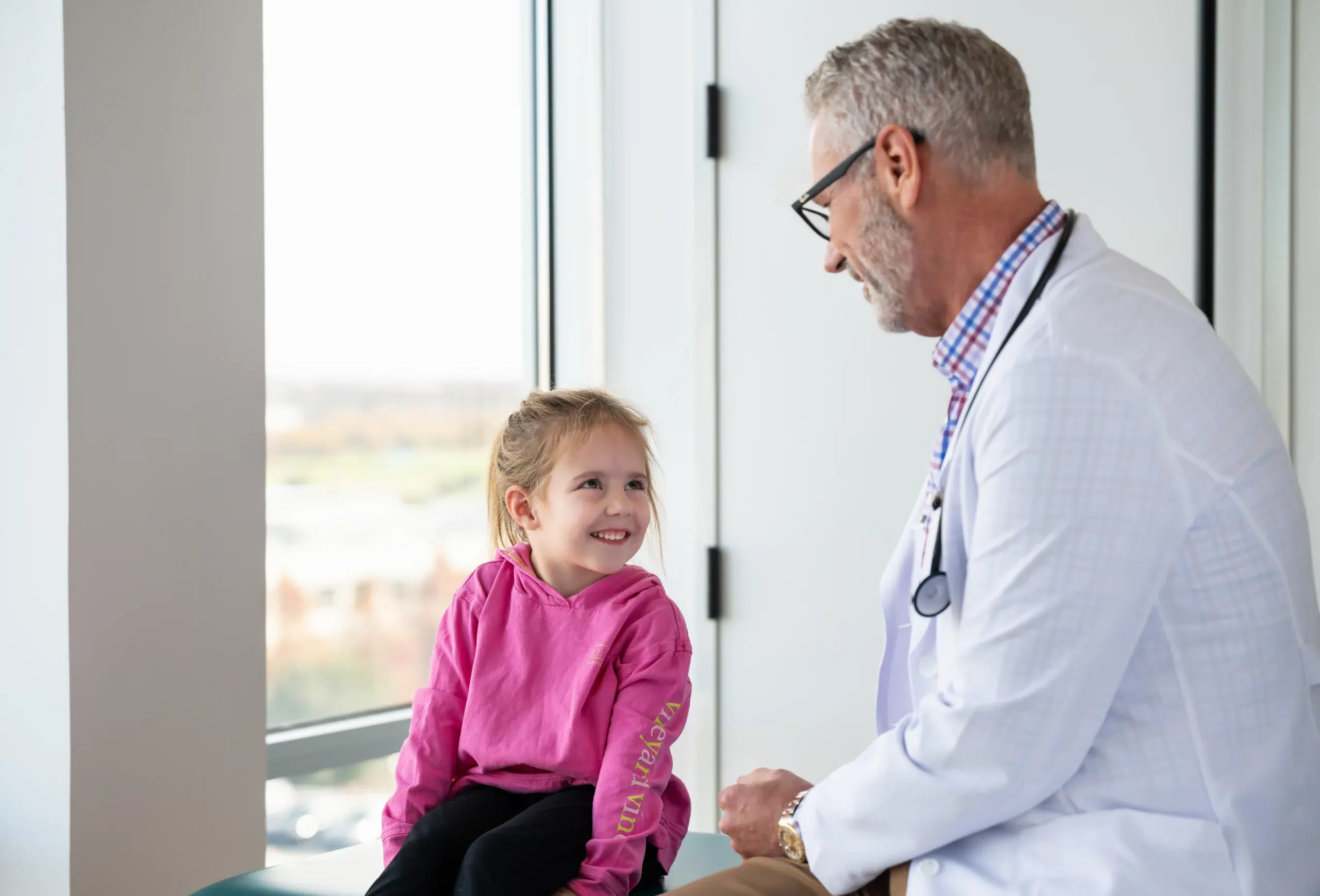 Male physician treating small child