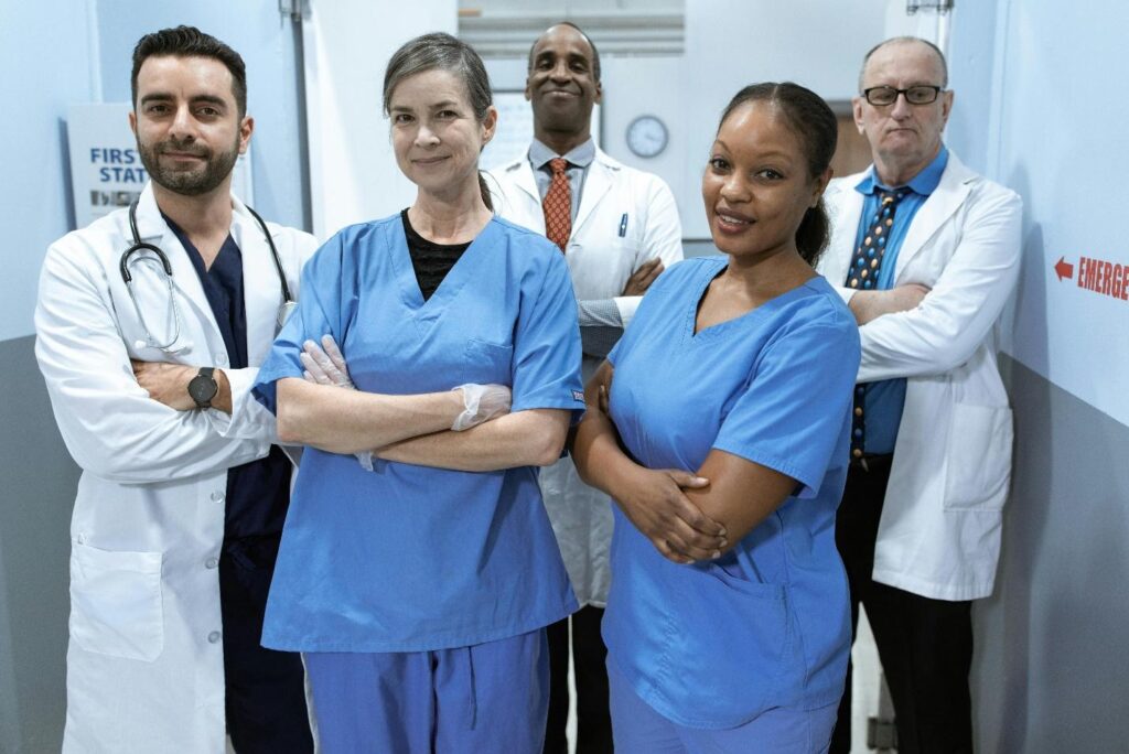Diverse group of nurses standing together triumphantly