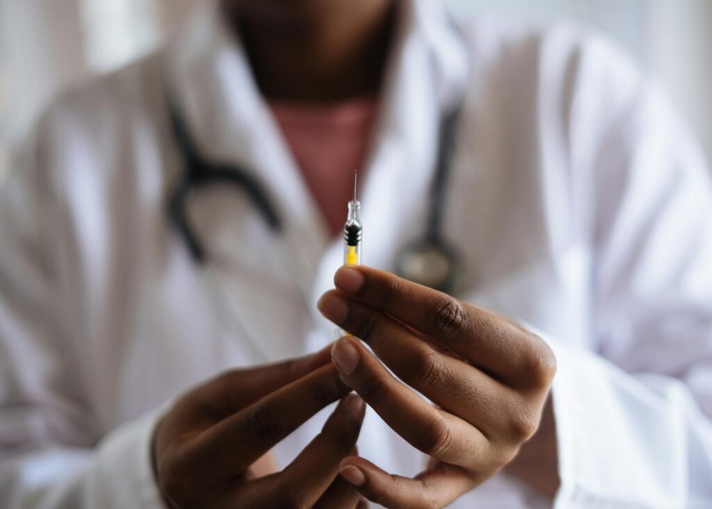 Nurse holding syringe with fluid