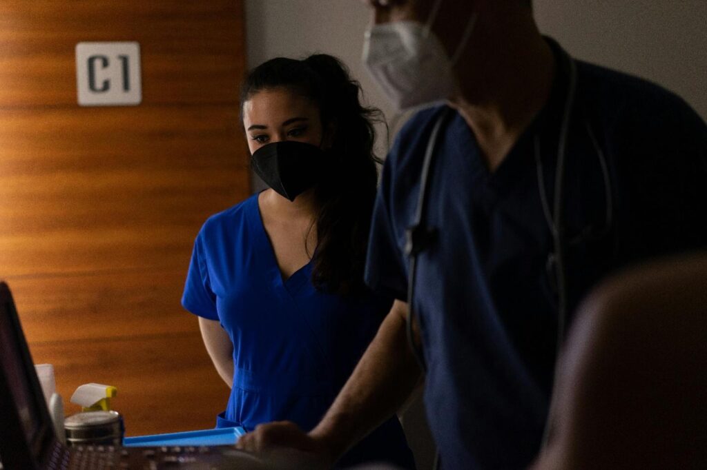 Picture of two nurses in a dark room