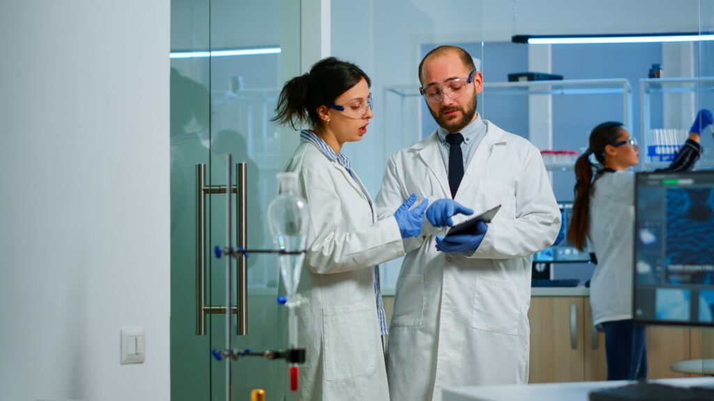 Chemist nurse explainig to doctor vaccine development