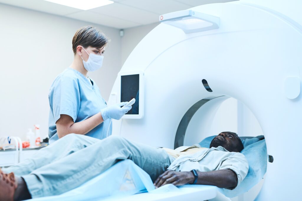 MRI tech preparing patient for scan