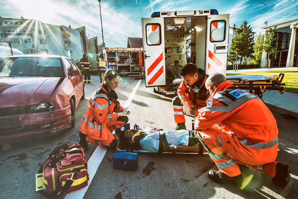 Paramedics assisting a patient after an accident