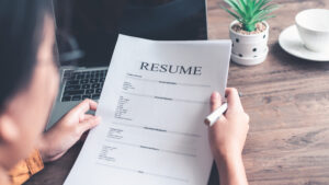 Picture of woman looking over resume.